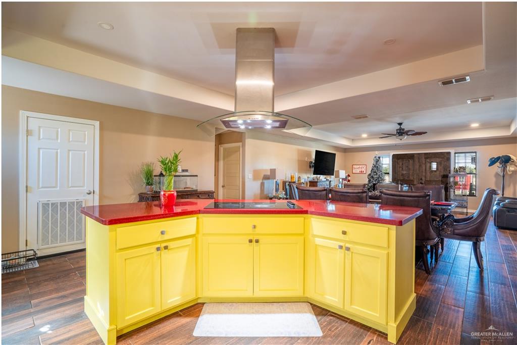 21604 North Val Verde Road Edinburg, TX 78542 - Photo 16 of 39 a view of a kitchen with kitchen island and a chandelier