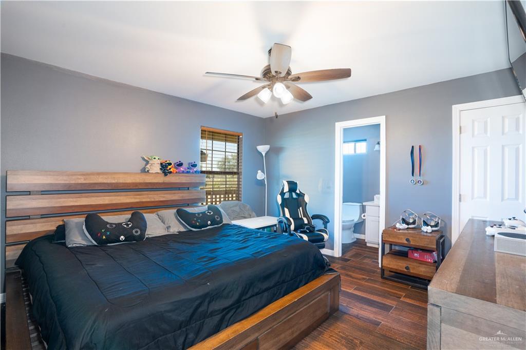 21604 North Val Verde Road Edinburg, TX 78542 - Photo 21 of 39 a bedroom with furniture and a chandelier