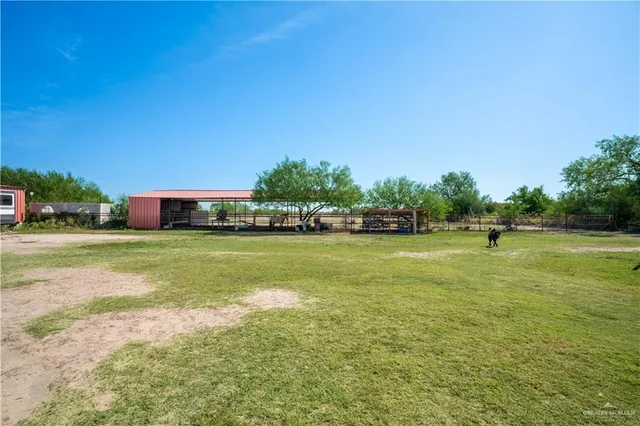 a view of a house with backyard sitting area and garden