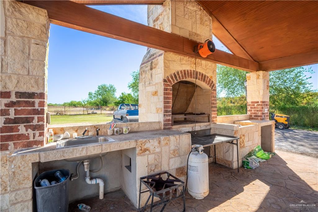 21604 North Val Verde Road Edinburg, TX 78542 - Photo 29 of 39 a view of a patio with table and chairs and potted plants