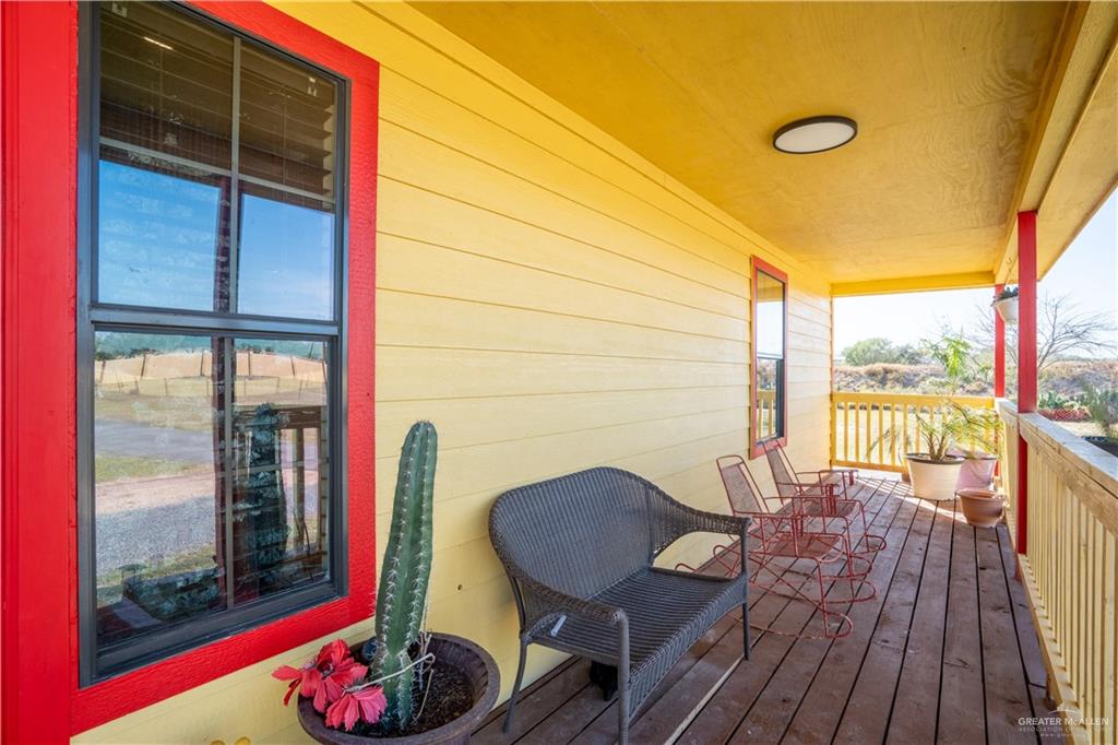 21604 North Val Verde Road Edinburg, TX 78542 - Photo 6 of 39 a view of a balcony with chairs and a potted plant