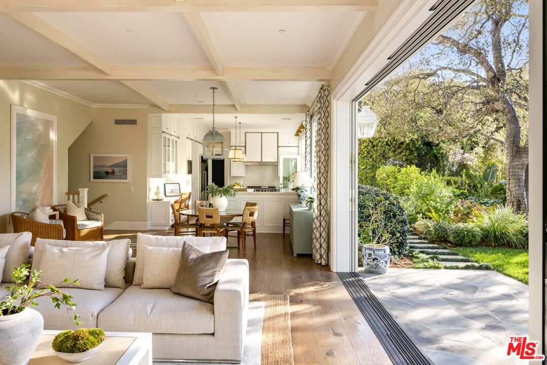 782 Ranch Lane Pacific Palisades, CA 90272 - Photo 12 of 53 a living room with patio furniture and a garden