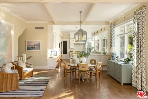 a large kitchen with a table and chairs