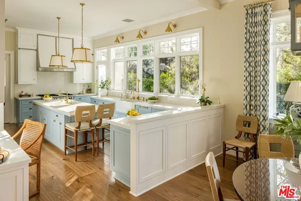 a view of a kitchen with dining table and chairs