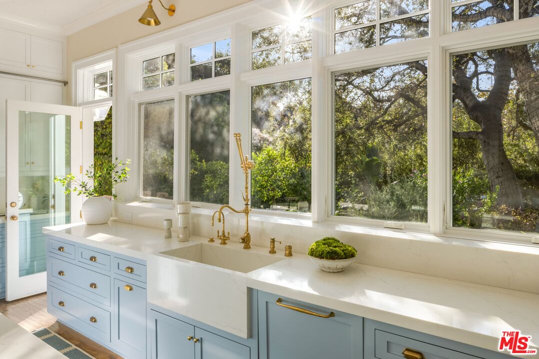 782 Ranch Lane Pacific Palisades, CA 90272 - Photo 21 of 53 a bathroom with a granite countertop sink and a large window