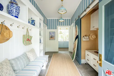 a living room with furniture and a baby crib