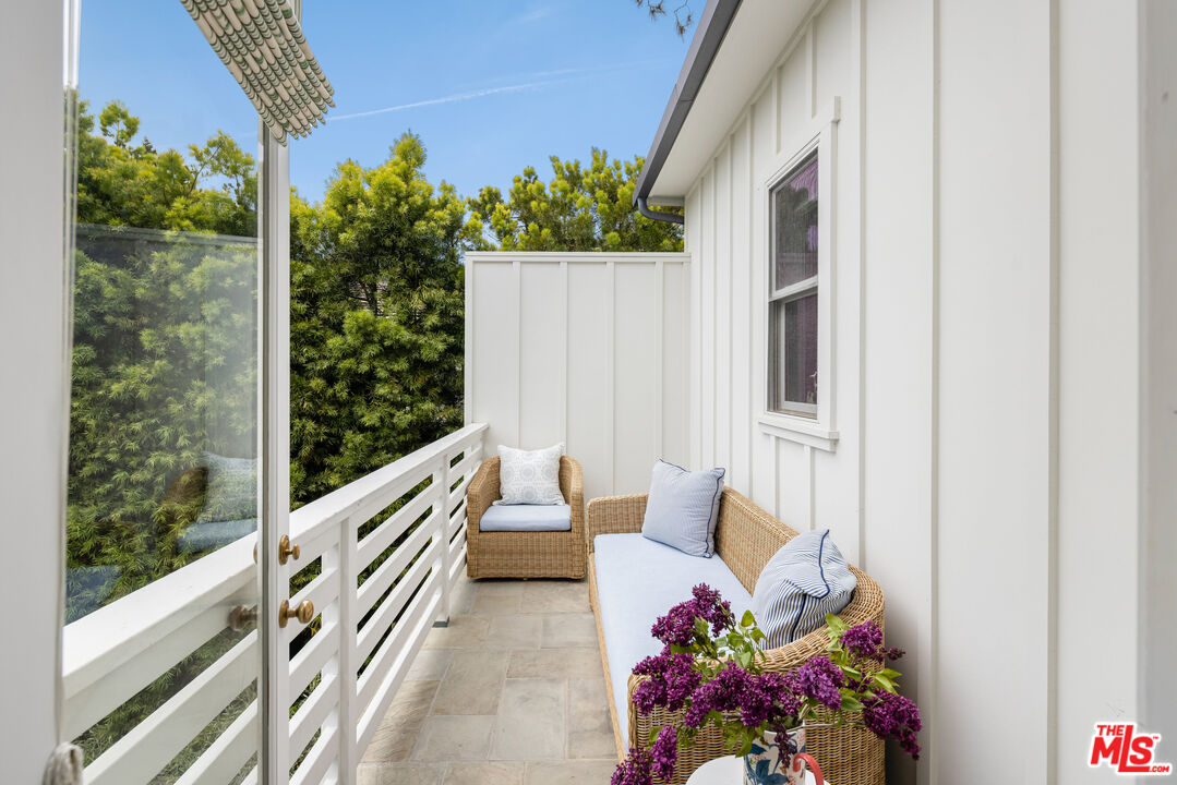 782 Ranch Lane Pacific Palisades, CA 90272 - Photo 28 of 53 a balcony with wooden floor and potted plant