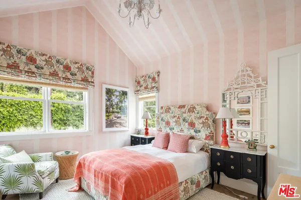 a bedroom with a bed and a chair