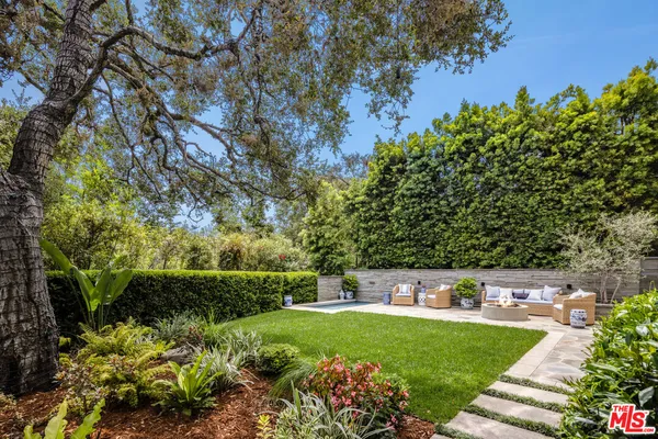 a view of a pathway of a house with a yard