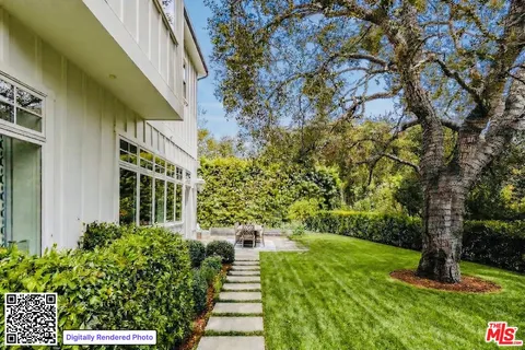 a view of a pathway of a house with a yard