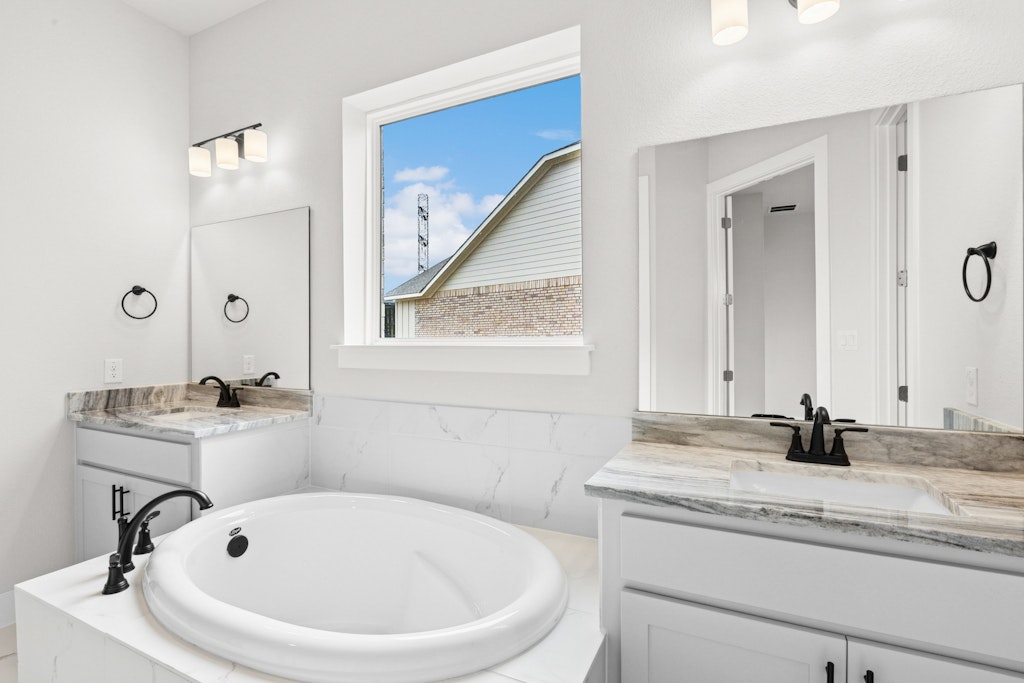 19600 Judys View Pflugerville, TX 78660 - Photo 16 of 34 a bathroom with a sink and a mirror