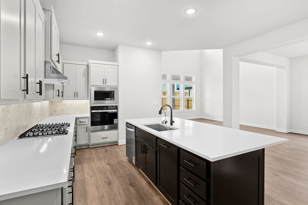 19600 Judys View Pflugerville, TX 78660 - Photo 9 of 34 a kitchen with stainless steel appliances a sink a stove a refrigerator and cabinets