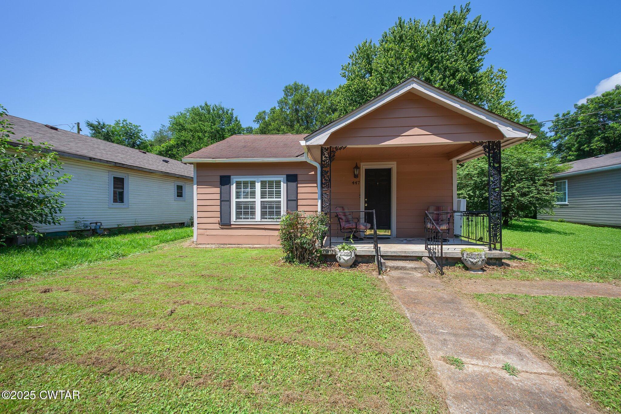 a front view of house with yard and green space