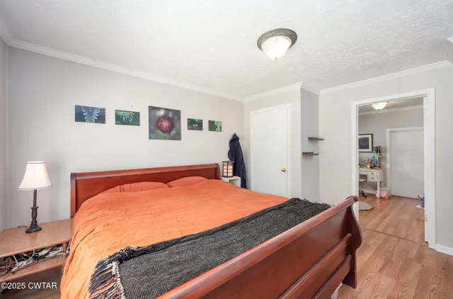 a bedroom with a bed and a lamp