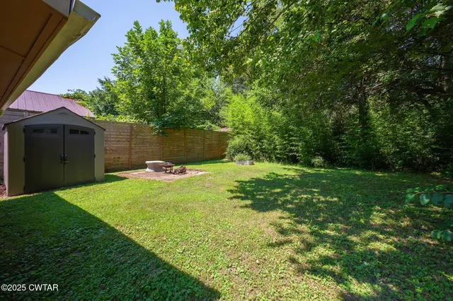 a view of a backyard with table and chairs and potted plants