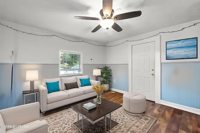 a living room with furniture potted plant and a window