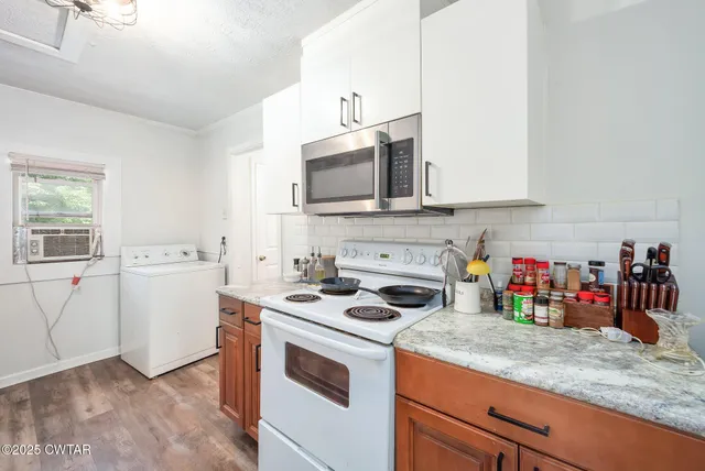 a kitchen with a stove and a microwave