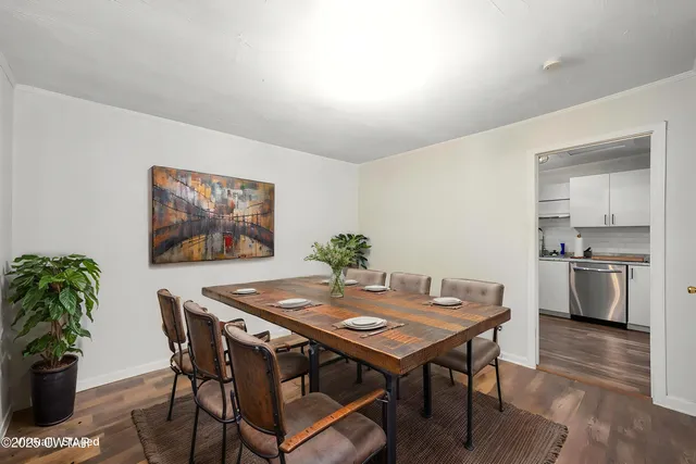 a view of a dining room with furniture and wooden floor