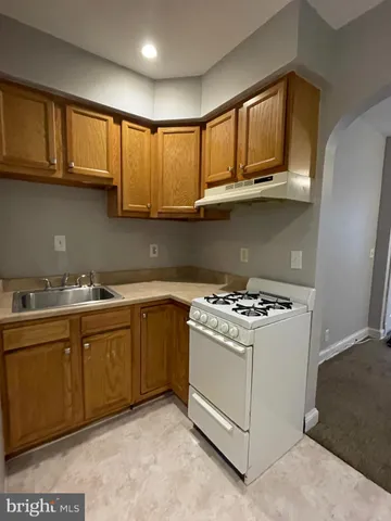 a kitchen with stainless steel appliances granite countertop a stove and a sink