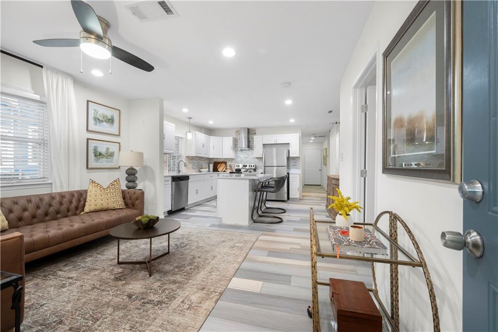 a living room with furniture and kitchen view