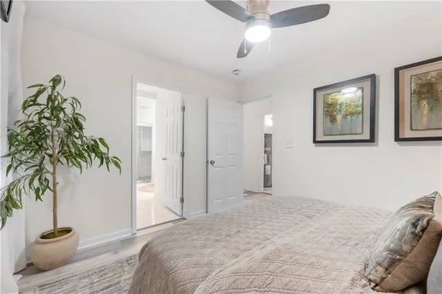 a bedroom with a bed and a potted plant