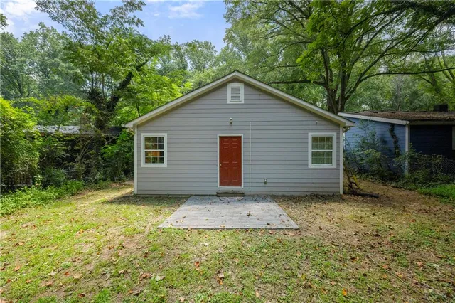 a view of a house with a yard and garage