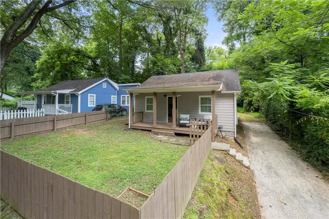 a view of a house with backyard porch and sitting area