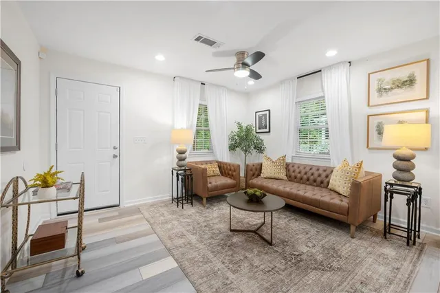 a living room with furniture and wooden floor
