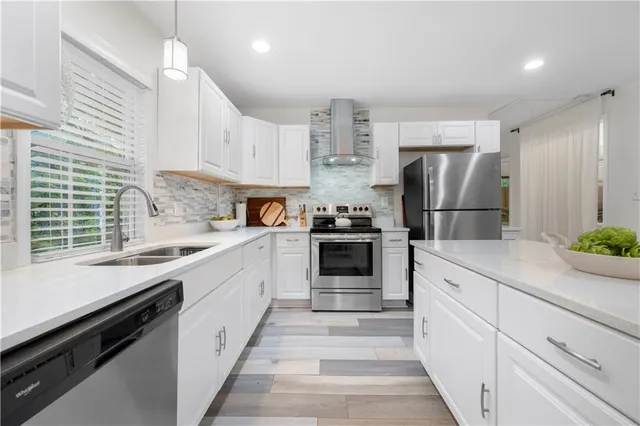 a kitchen with refrigerator cabinets and a sink