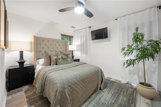 a bedroom with a bed and a potted plant