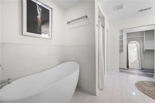a bathroom with a granite countertop sink mirror and bathtub