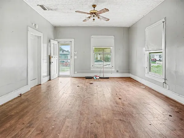 a view of a livingroom with wooden floor and furniture