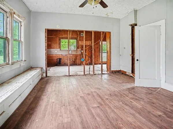 a view of a room with wooden floor and a window
