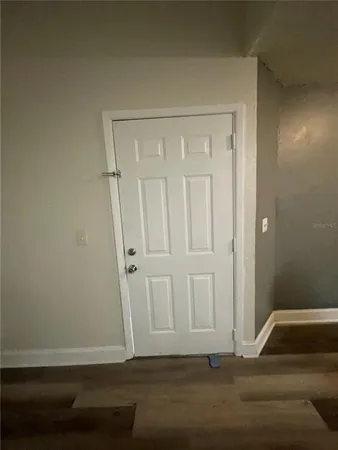 a view of room with wooden floor