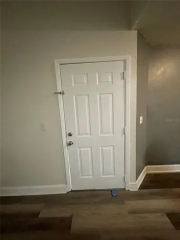 a view of room with wooden floor