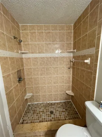 a view of walk in closet with wooden floor