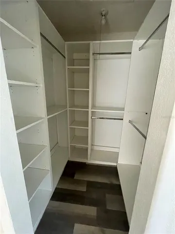 a bathroom with a granite countertop double vanity sink and mirror