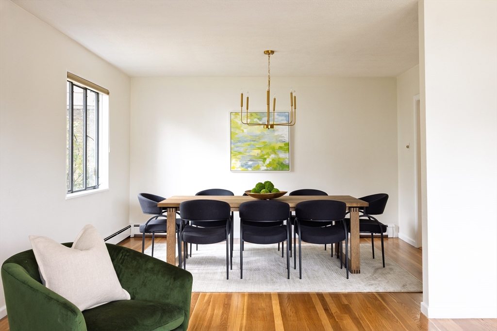535 Clinton Road Brookline, MA 02467 - Photo 5 of 12 a view of a dining room with furniture and chandelier