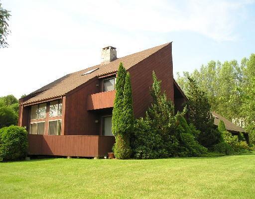 a front view of house with yard and trees