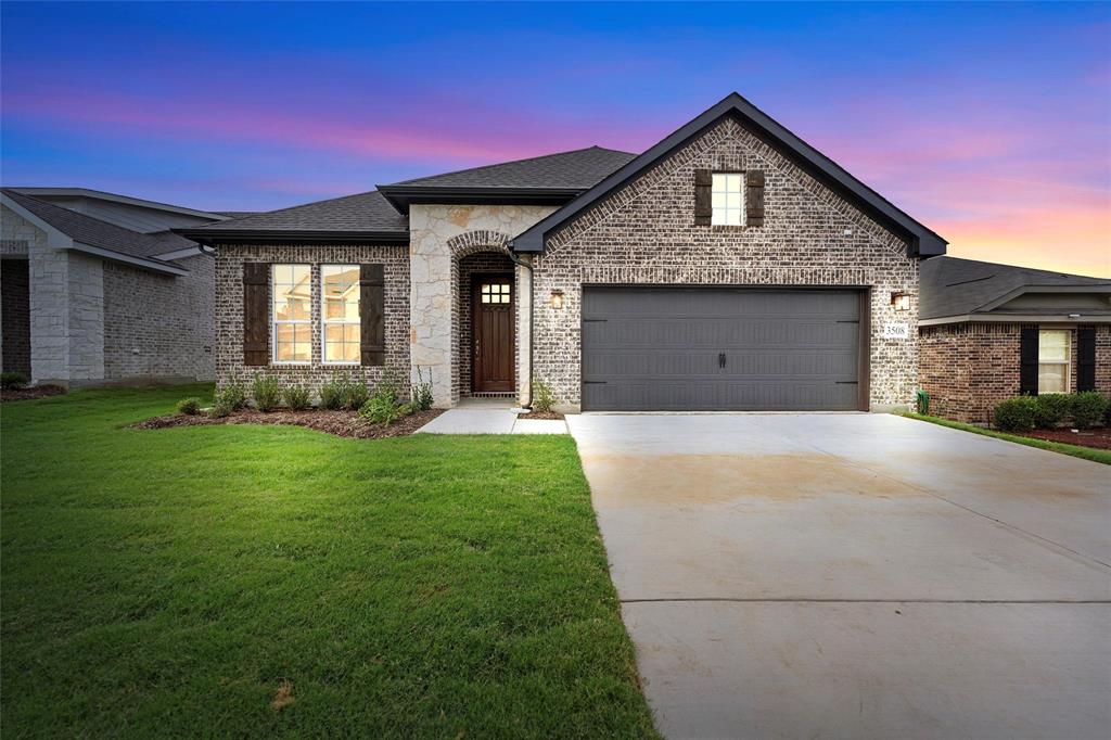 a front view of a house with a yard and garage