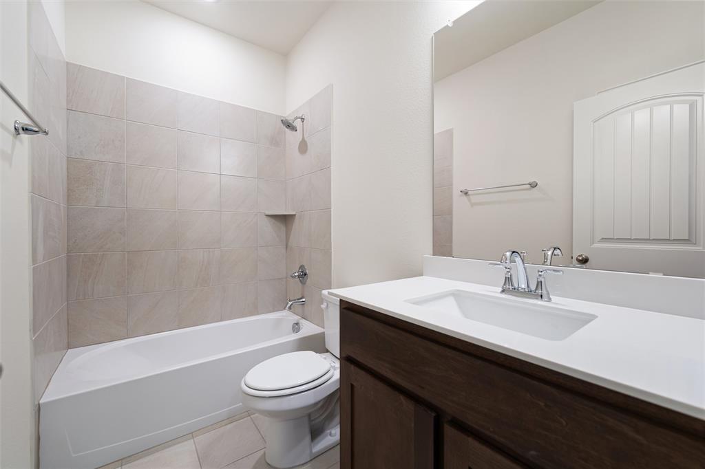 3508 Columbus Street Gainesville, TX 76240 - Photo 17 of 38 a bathroom with a sink a toilet and shower