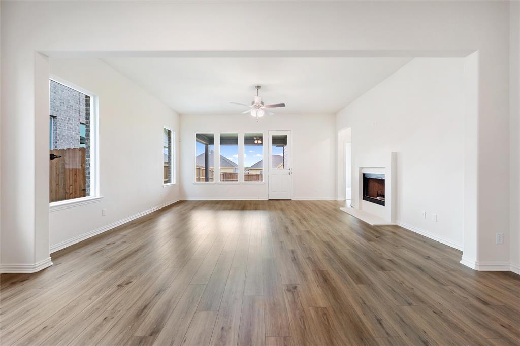 3508 Columbus Street Gainesville, TX 76240 - Photo 20 of 38 an empty room with wooden floor and windows