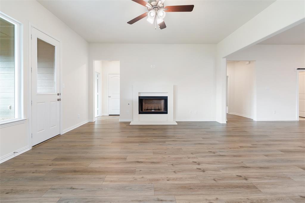 3508 Columbus Street Gainesville, TX 76240 - Photo 23 of 38 a view of an empty room with wooden floor and a ceiling fan
