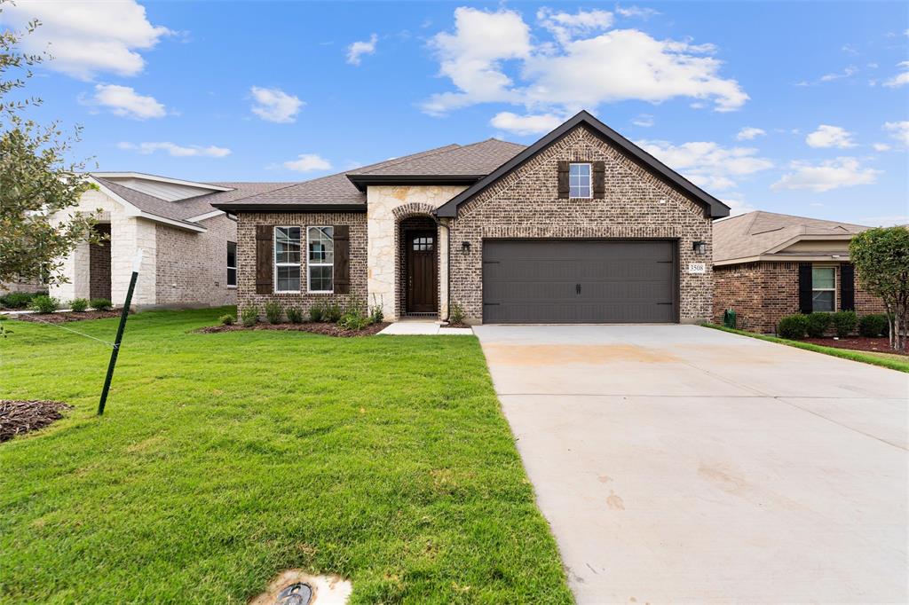 3508 Columbus Street Gainesville, TX 76240 - Photo 3 of 38 a front view of a house with a yard and garage