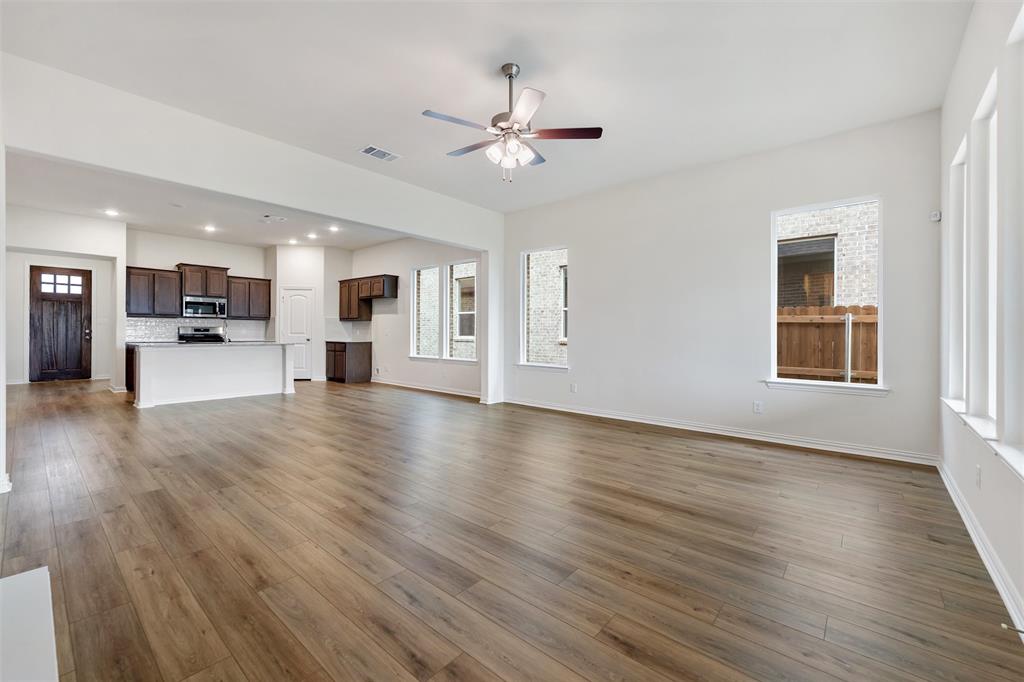 3508 Columbus Street Gainesville, TX 76240 - Photo 31 of 38 a view of a livingroom with a ceiling fan window a ceiling fan and wooden floor