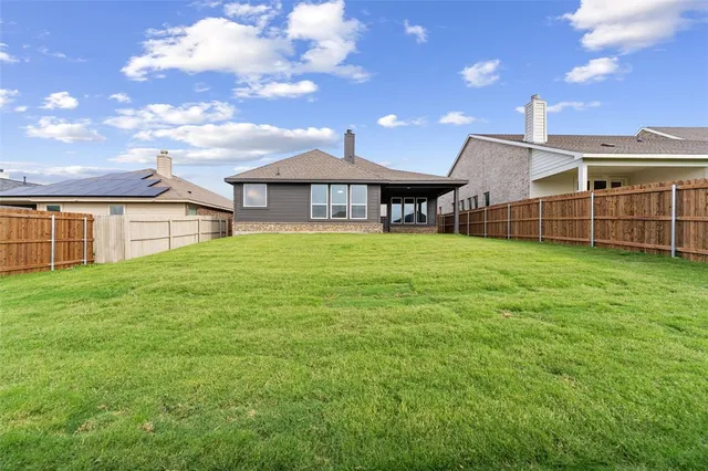a view of a house with a yard and porch