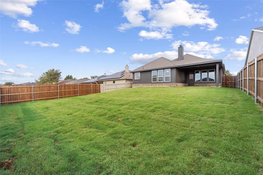 3508 Columbus Street Gainesville, TX 76240 - Photo 36 of 38 a view of a house with a big yard and a large tree