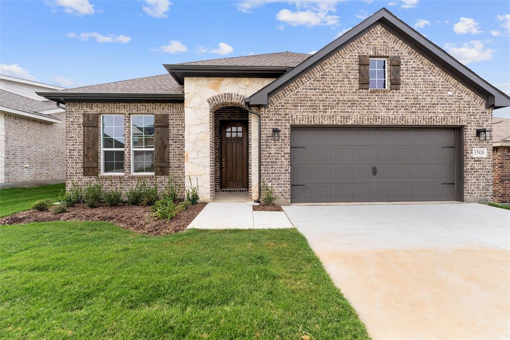 3508 Columbus Street Gainesville, TX 76240 - Photo 6 of 38 a front view of a house with a yard and garage