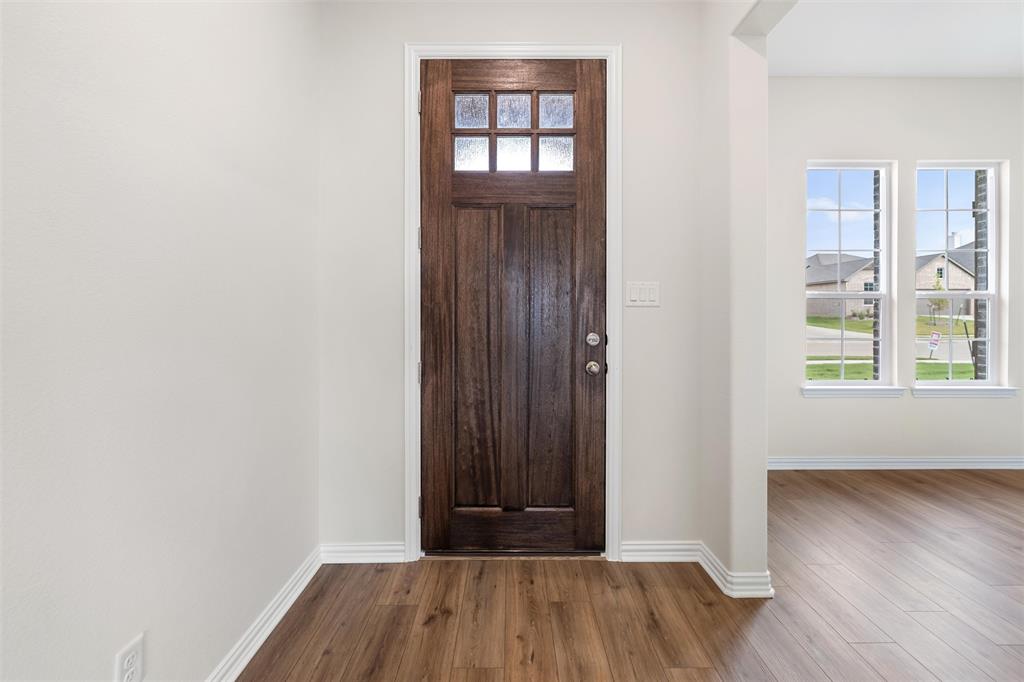 3508 Columbus Street Gainesville, TX 76240 - Photo 8 of 38 an empty room with wooden floor and windows