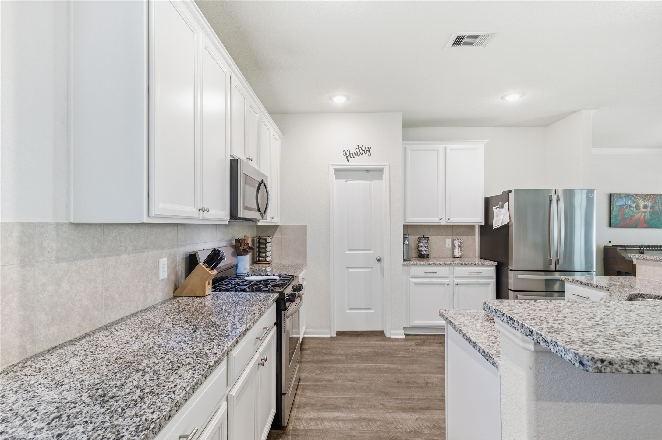 16536 Aransas Conroe, TX 77303 - Photo 12 of 40 a kitchen with stainless steel appliances granite countertop a sink stove and refrigerator